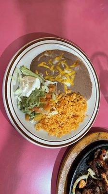 Rice and refried beans with guacamole, pico de galló and sour cream