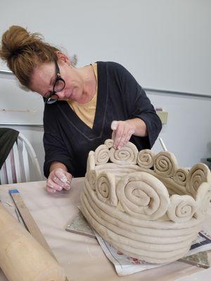 Creating a ceramic planter.