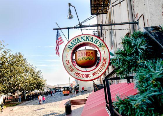 On the east end of River Street, in Historic Savannah, Georgia you'll find our copper kettle hanging above a red awning.