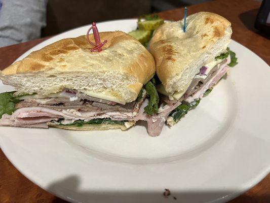 Smoked Submarine with ham, turkey and brisket with pepper jack cheese, lettuce, tomato and red onion and their special sauce.