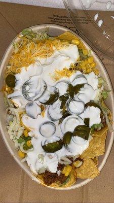 Nachos Bowl -Ground Beef ,Toppings- Lettuce,Cilantro,Corn Kernels,Shredded Cheddar,Sour Cream,Shredded Mozzarella & Pickled Jalapeños.