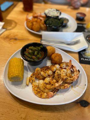 Grilled shrimp with corn on the cob and green beans.