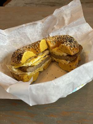 Sausage, egg, salt & pepper on egg everything bagel