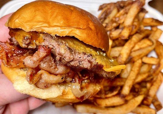 Cheddar Bacon Burger - 1/4lb beef patty, cheddar, applewood smoked bacon, grilled onions, bbq sauce on a potato bun + fries