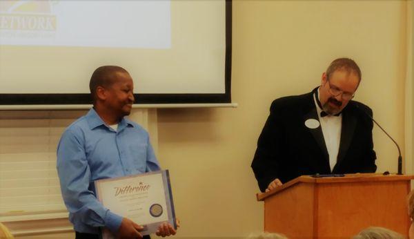 Zim Dube winning the award for Caregiver of the Year at the Annual Caregiver Recognition Dinner, October 2018