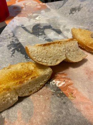 Toasted sesame seed bagel with butter. Dried bread.