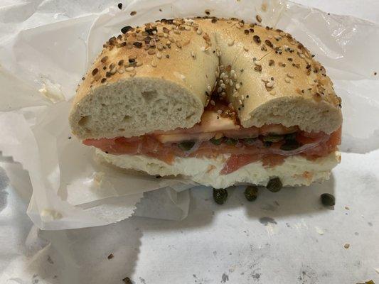 Lox bagel sandwich with tomato, onion, capers, cream cheese.  Delicious.