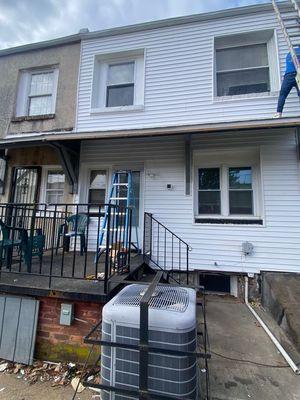 The workers working on the siding if the house