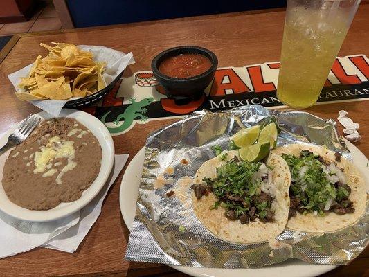 Bland beans, bland salsa, and flavorless carne asada tacos.