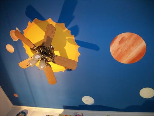 Solar system on a ceiling. The little boy customer didn't want rings on Saturn because it looks like Tatooine!