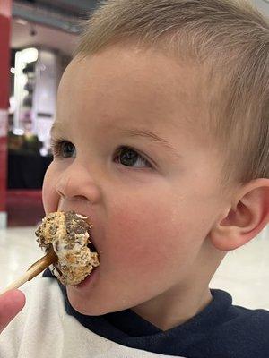 Caramel and butterfinger covered marshmallow on a stick