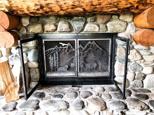 Custom double door fire place screen with a wax and patina finish.