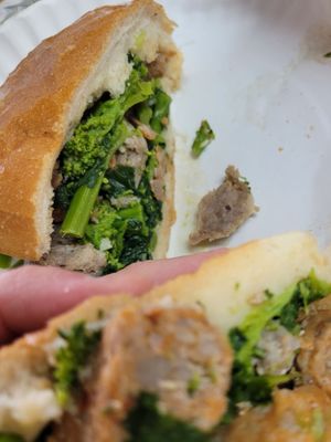 Tender sweet and spicy sausage, garlic and broccoli rabe. Tasty sandwich on a fresh role. I  could taste the love.