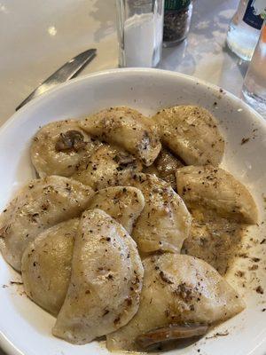 Potato and sauerkraut pierogis with mushroom sauce.