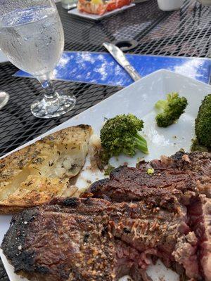 Burned, overcooked porterhouse steak, cold broccoli and cold, hard potato