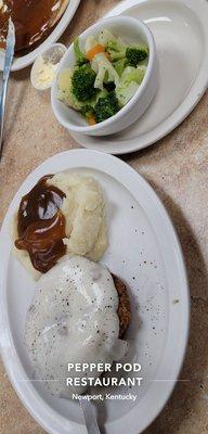 Country fried steak, mashed potatoes, mixed vegetables .   Mom's pancakes off to the side.