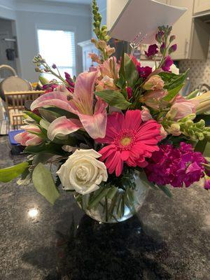 Gerber daisies, roses, lilies, tulips, snapdragons, and more in a beautiful rose bowl. Highly recommend.