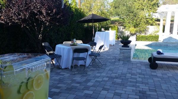 Table for 6 with grey chairs and standing height tables in background.