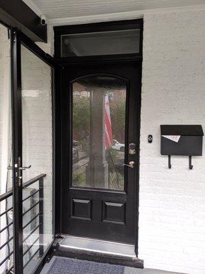 Front door with storm door is open