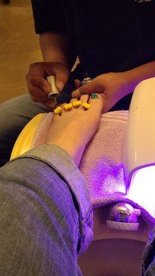 Gel polish being painted on for my pedicure