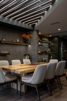 Opal, a custom Home in Ascaya features an intimate dining corner finished with a wine room, ready for guests.