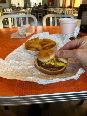 Single burger with onions that have been sautéed, cheese and mustard. Hope it's good because there's not much to it.