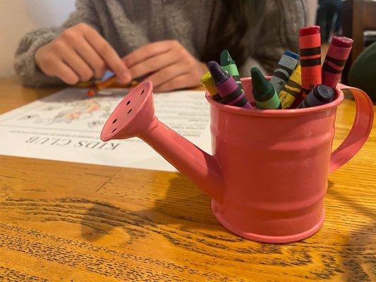 Cute little watering can with crayons they give to color their kids menu