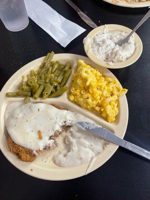 Country fried steak with white pepper gravy, grean beans, Mac and cheese, rice and white gravy.