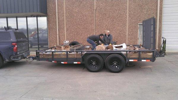 New trailer loaded up with rocks and old trailer tires.