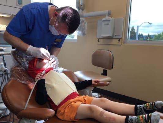 Dr. Mitchell inspects our kiddo's teeth. No cavities. #win