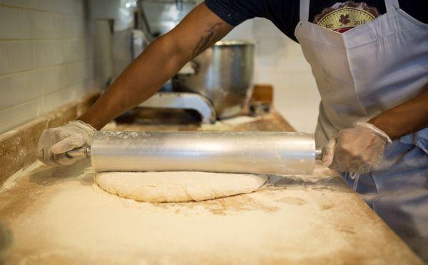 Biscuits dough being rolled in our scratch kitchen