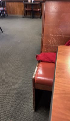 Worn out table and chairs and the table is shorter than the chairs.