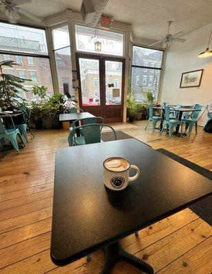 Love the fresh plants, natural light, and adorable teal chairs