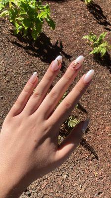 Oval white with sparkles nails, with gold butterfly stickers- one of my favs acrylics