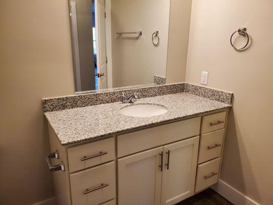 The bathroom is spacious and so well designed. Beautiful counter tops.