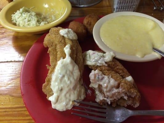 Two catfish filets, cheese grits, hushpuppies and perfect coleslaw.