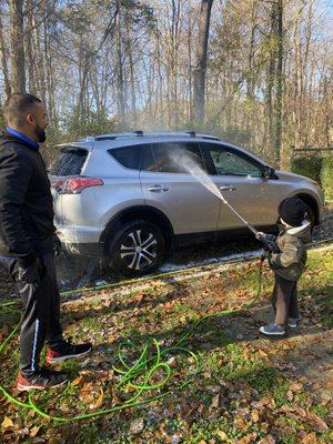 Nick letting my son have a turn washing the car