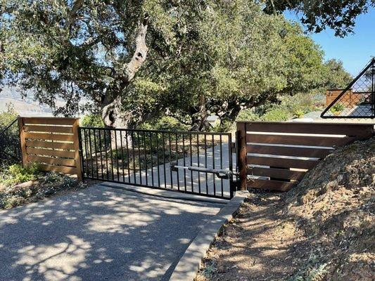 12' Aluminum gate with IPE fence on either side.