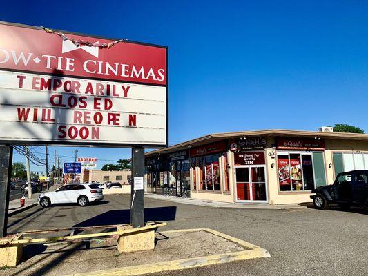 Between Bow Tie Theatres & Badshah Farmers Market, close to the southwest corner of Herricks Rd & Hillside