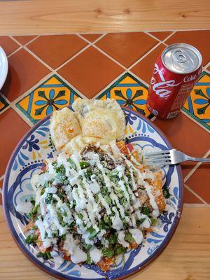 Chilaquiles con birria and 2 eggs over easy