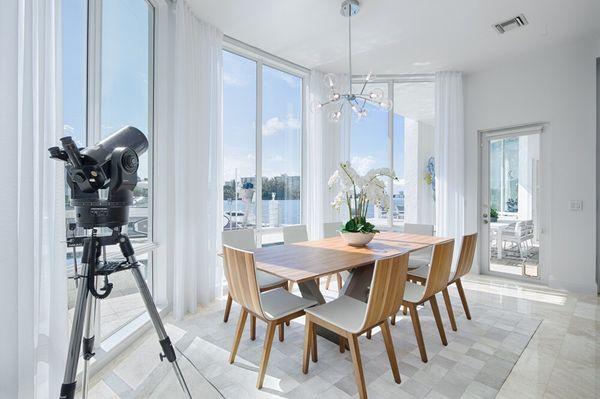 The focus of this modern dining room is the outside views of the water