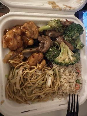 Half fried rice half chow mein plate with spicy orange chicken and broccoli beef