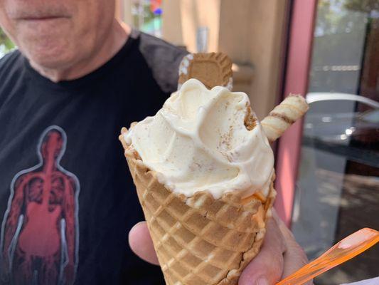 Scoop of Orange Cream Gelato topped with a scoop of Italian Cookie Gelato  a biscoff cookie.