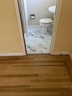 Luxury vinyl tile in small bath with light color to make the space look bigger