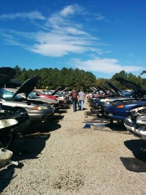 Husband and son having fun at Pick-N-Pull searching for car parts.