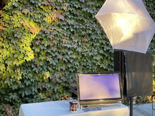 Open air booth with a natural vine wall backdrop