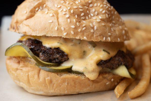 Our signature Pickle Burger with housemade zucchini pickles and tangy burger sauce.