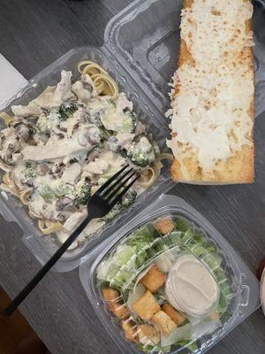 Fettuccini Al Fredo with chicken and mushroom, cheese garlic breads and side Caesar salad