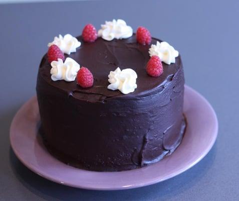 Dark & White cake - chocolate cake filled with white buttercream and fresh raspberries, covered in dark chocolate icing