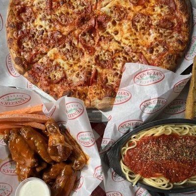 Hot pepperoni pizza next to a crispy order of wings with our famous ranch and a classic order of spaghetti with our homemade marinara sauce.